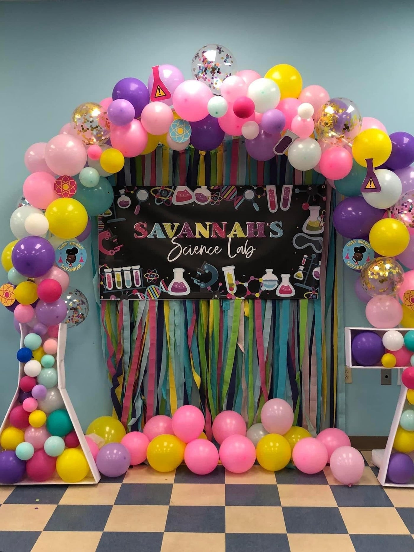 girls science party decorations with personalized banner and balloon arch