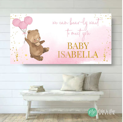 teddy bear baby shower banner in pink and gold on shiplap wall