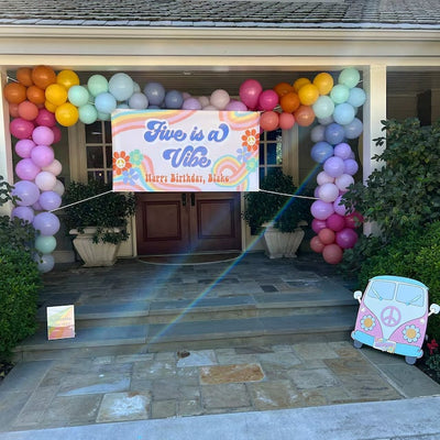 Five is a Vibe groovy birthday banner with rainbow balloon garland