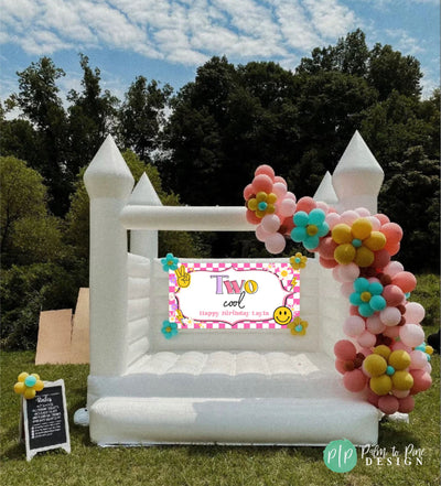 Two Cool birthday banner on bounce house with daisy balloon garland