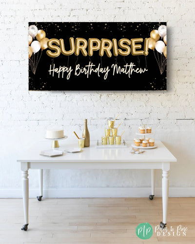 black and gold surprise party banner with gold dessert table