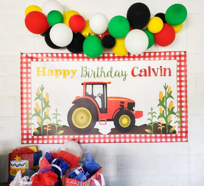 red tractor birthday banner with balloon garland