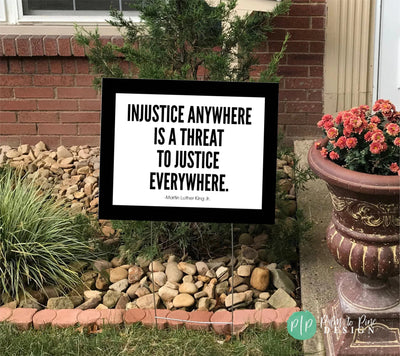 Black and White human rights yard sign reading Injustice anywhere is a threat to justice everywhere