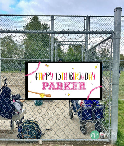 girls softball birthday banner at softball game attached to dugout fence