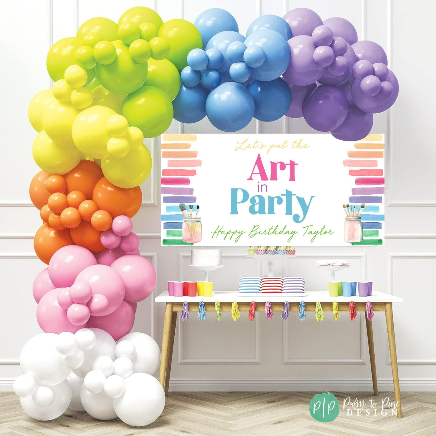 bright rainbow girls birthday backdrop for art birthday party with personalized &quot;Art in Party&quot; birthday banner and rainbow balloon garland
