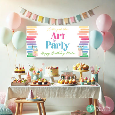 colorful art birthday party dessert table with personalized &quot;Art in Party&quot; birthday banner in rainbow watercolor designs