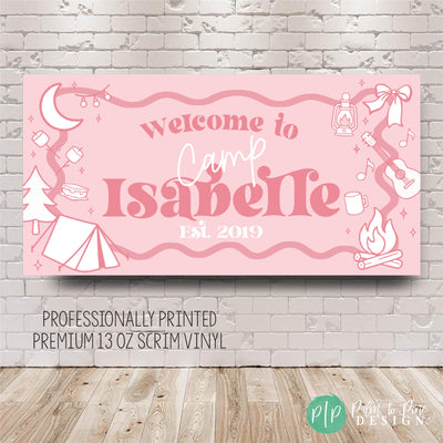 Custom glamping birthday party banner in preppy pink and girly camping theme, styled on a dessert table with cupcakes, cookies, and camp-inspired decorations