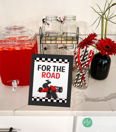 For the Road racecar birthday party decoration with road graphic, race car illustration, and checkered background at drink station