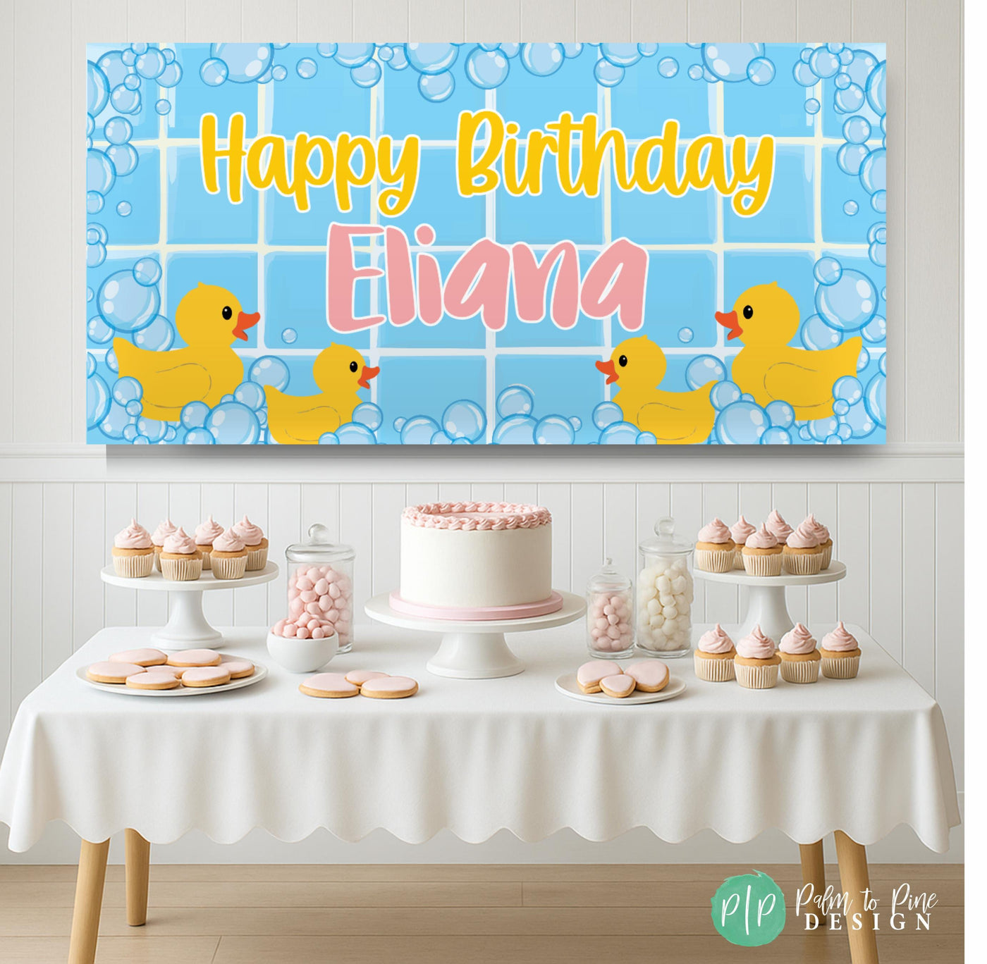 Cute pink and yellow duck banner with bubbly accents for a bubble bath baby shower or rubber duck birthday, set in front of a pink dessert table