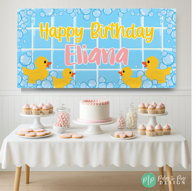 Cute pink and yellow duck banner with bubbly accents for a bubble bath baby shower or rubber duck birthday, set in front of a pink dessert table