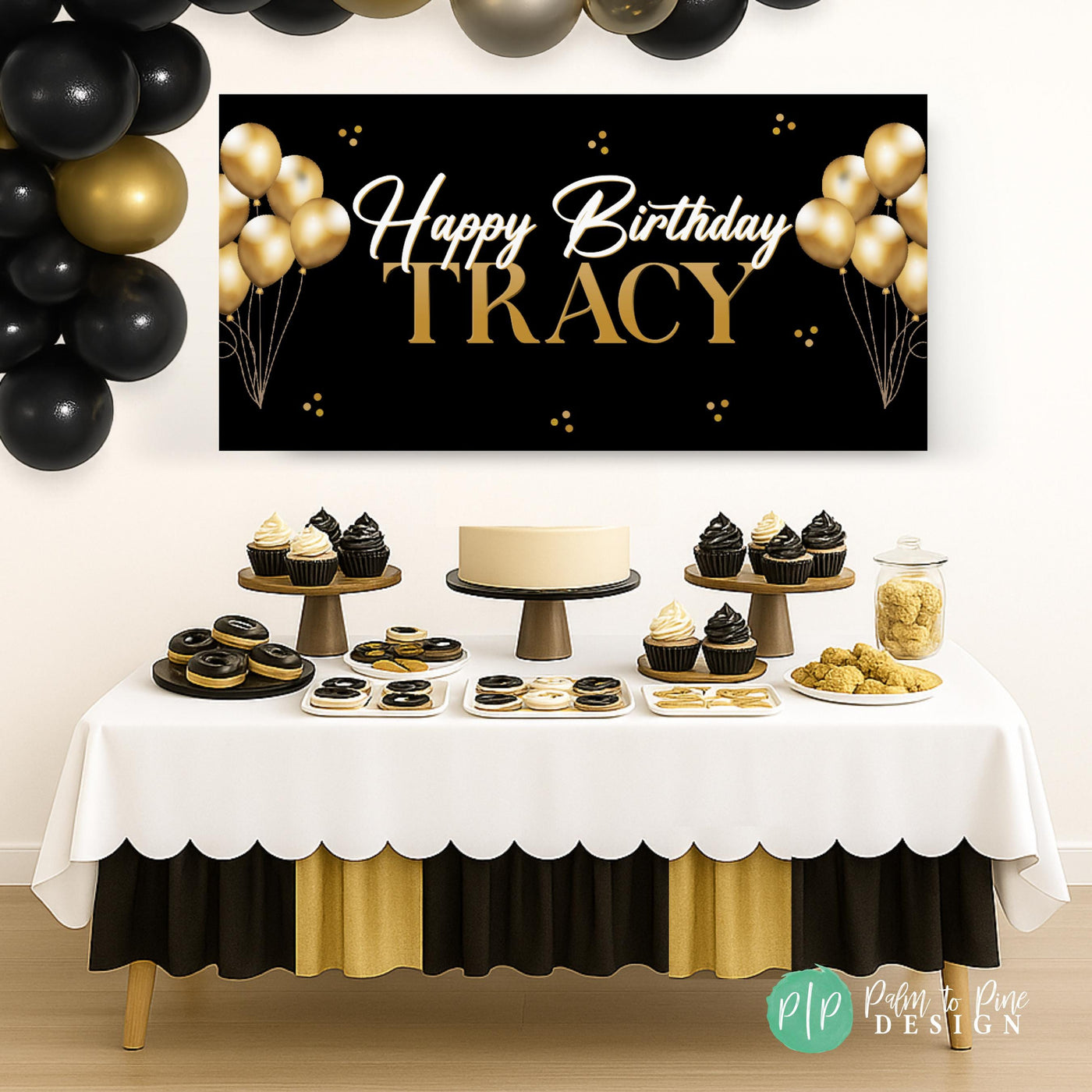 Black and gold vinyl banner hanging behind dessert table