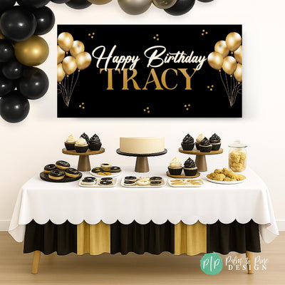 Black and gold vinyl banner hanging behind dessert table